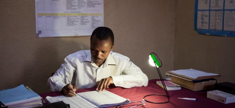 doctor working under the light of a lamp