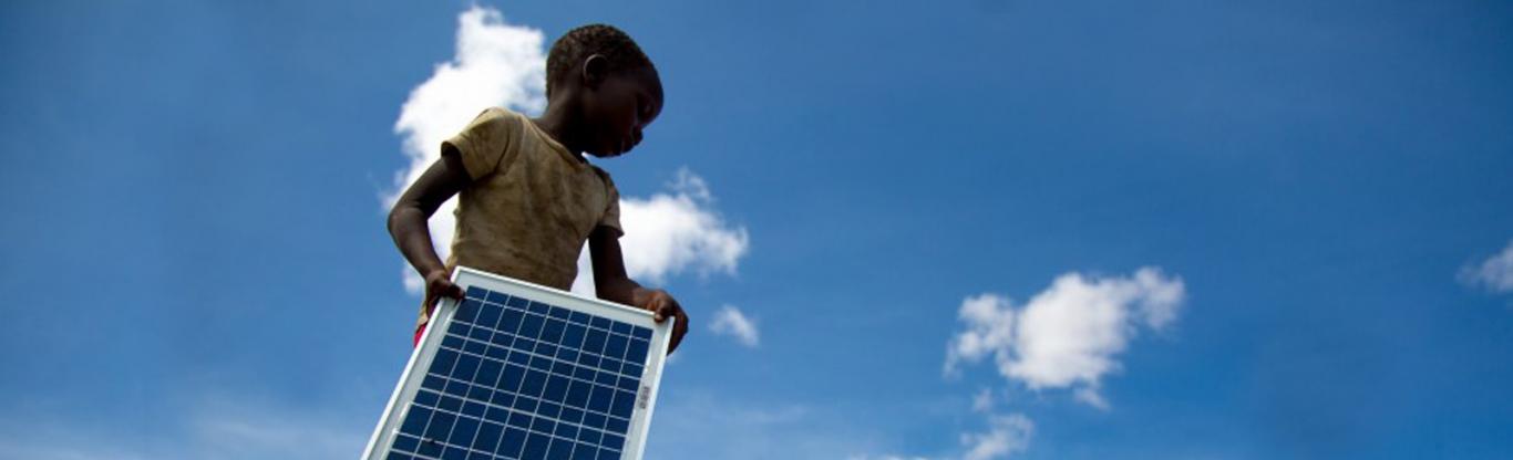 girl holding solar photovoltaic panel, image by Pawame