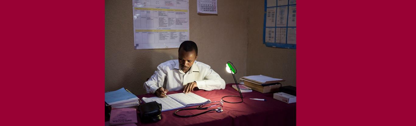 doctor working under the light of a lamp
