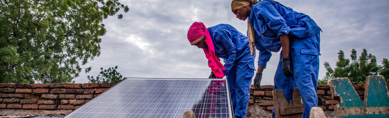 WOMEN WORKING on cleaning PV panels