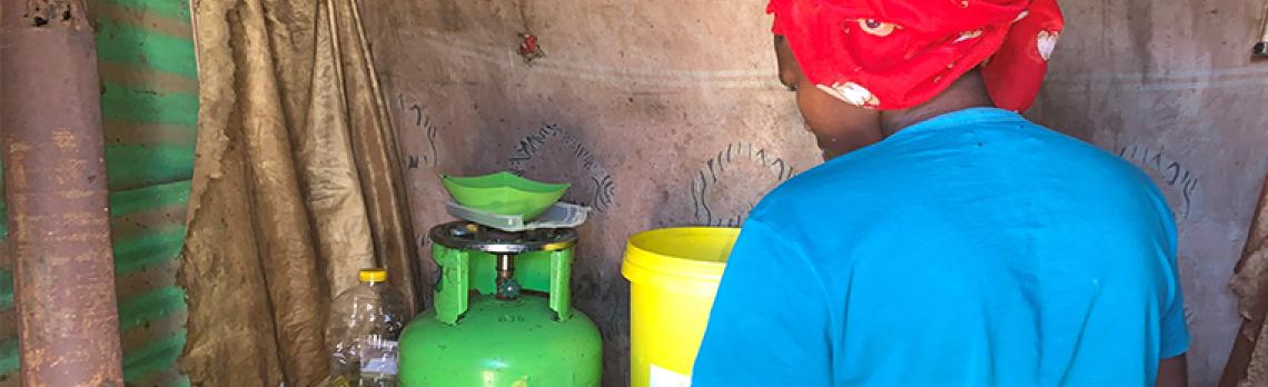 Soweto_Settement_Woman_Cooking_MarjorieAraya Woman cooking in a settlement in Soweto, South Africa
