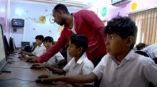 children working on computers in a school in Yemen