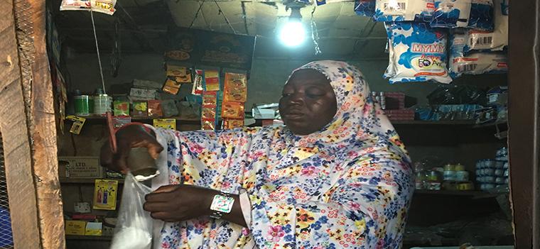 Store owner powered by solar PV mini grid. Besanti Village, Nigeria. Photo by Marjorie Araya, The World Bank Store owner powered by solar PV mini grid. Besanti Village, Nigeria. Photo by Marjorie Araya, The World Bank