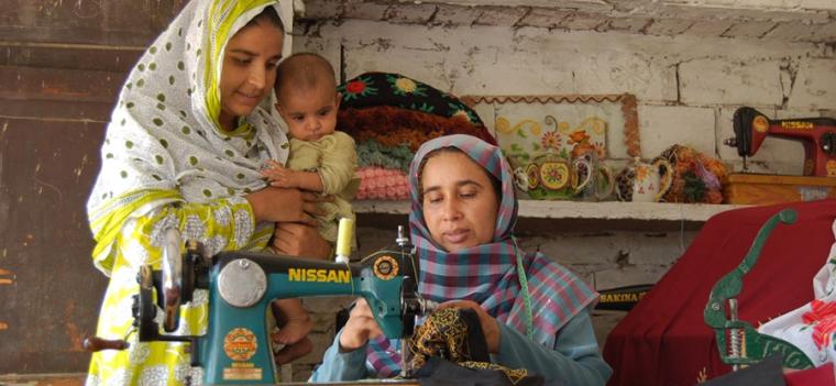 Pakistan, women at sewing machine Pakistan, women at sewing machine